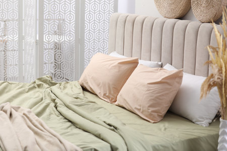 Bed with new pistachio linen in room. Interior designの写真素材