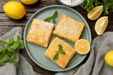 Tasty lemon bars served on wooden table, flat layの写真素材