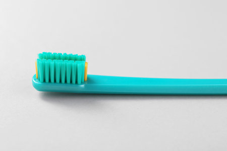 One plastic toothbrush on light background, closeupの写真素材