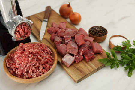 Electric meat grinder with beef and products on white marble table, above viewの写真素材