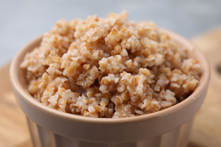 Tasty wheat porridge in bowl on table, closeupの写真素材