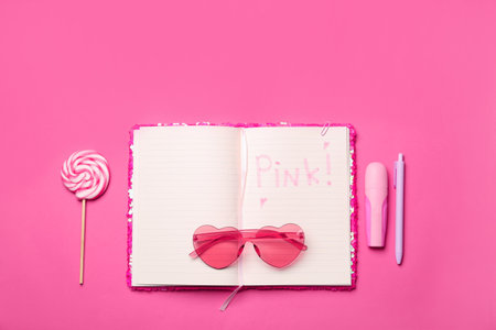 Flat lay composition with word Pink in notebook on color backgroundの写真素材