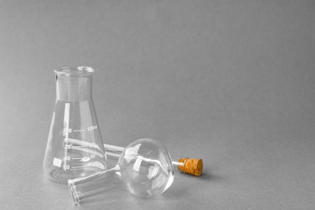 Different laboratory glassware on gray background, space for textの写真素材