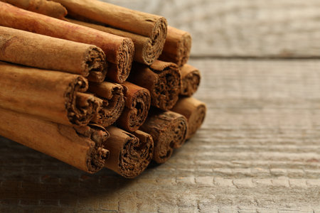Cinnamon sticks on wooden table, closeup. Space for textの写真素材