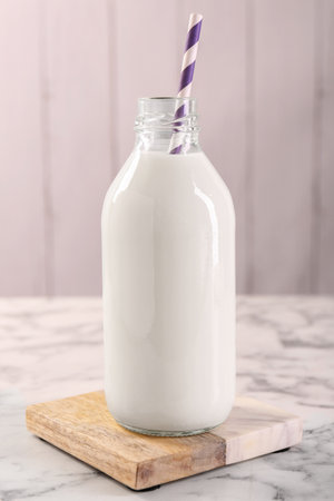 Bottle of tasty milk on white marble tableの写真素材
