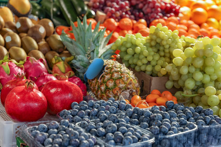 Many different fresh fruits on counter at wholesale marketの写真素材
