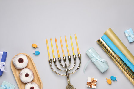 Flat lay composition with Hanukkah menorah and gift boxes on light gray background. Space for textの写真素材
