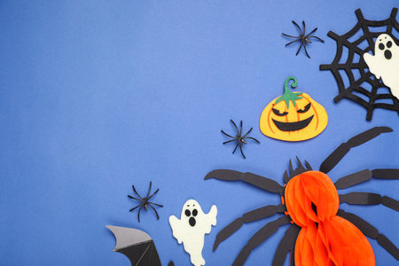 Flat lay composition with Halloween decor on blue background, space for textの写真素材