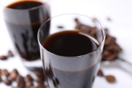 Glasses of coffee liqueur on blurred background, closeupの写真素材
