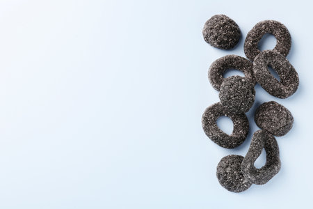Tasty liquorice candies on light blue background, top view. Space for textの写真素材