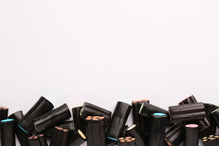 Tasty liquorice candies on light background, top view. Space for textの写真素材