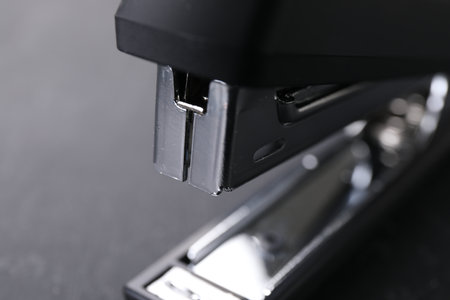 One black stapler on gray background, closeupの写真素材