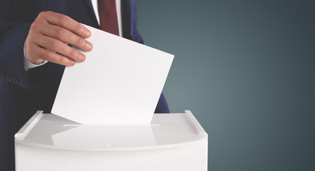 Man putting his vote into ballot box on gradient color background, closeup. Banner design with space for textの写真素材