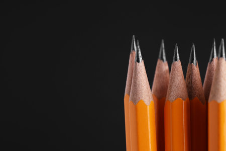 Many graphite pencils on black background, macro view. Space for textの写真素材