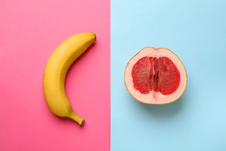 Banana and half of grapefruit on color background, flat lay. Sex conceptの写真素材