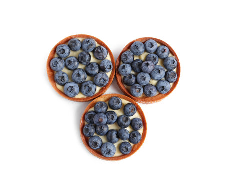 Tartlets with fresh blueberries isolated on white, top view. Delicious dessertの写真素材