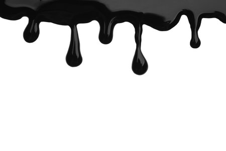 Black viscous liquid flowing on white backgroundの写真素材