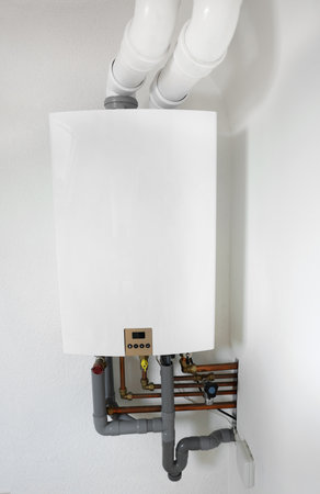 Modern gas boiler on white wall indoorsの写真素材