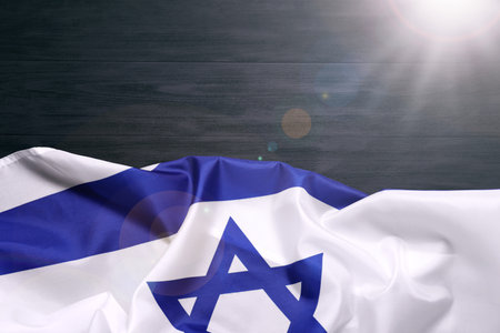 Flag of Israel on black wooden background, top view and space for text. National symbolの写真素材