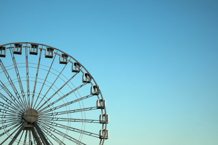 Big Ferris wheel against light blue sky. Space for textの写真素材