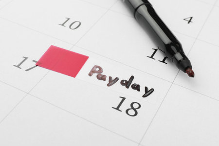 Black felt pen on calendar page with marked payday date, closeupの写真素材