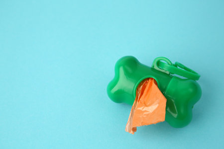 Dispenser with dog waste bags on light blue background, above view. Space for textの写真素材