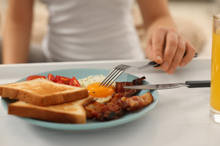 Woman having breakfast on bed at home, closeupの写真素材