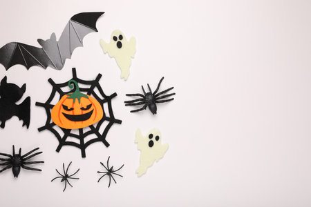 Flat lay composition with Halloween decor on white background, space for textの写真素材