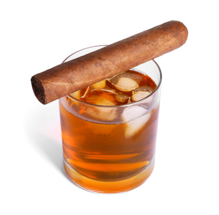 Glass of whiskey and cigar isolated on whiteの写真素材