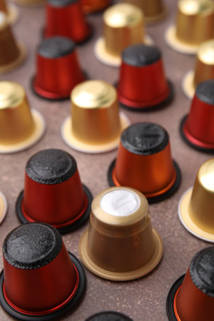 Many coffee capsules on brown table, closeupの写真素材