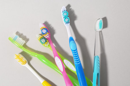 Many different toothbrushes on light background, flat layの写真素材