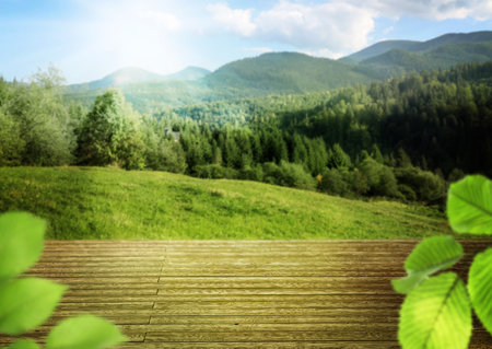 Empty wooden table in mountains on sunny day. Space for designの写真素材