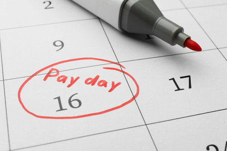 Red felt pen on calendar page with marked payday date, closeupの写真素材