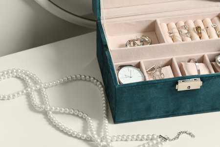 Jewelry box with many different accessories on white tableの写真素材