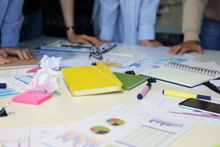 Team of employees working with charts at table, closeup. Startup project