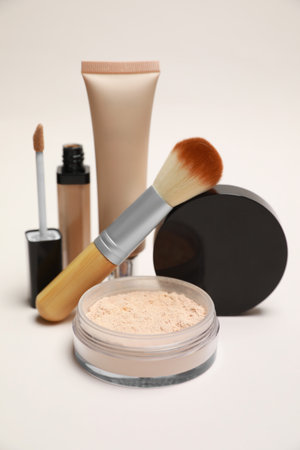 Loose face powder and other makeup products on light background, closeupの写真素材