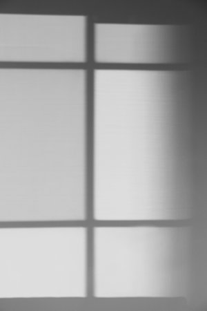 Light and shadow from window on wallの写真素材