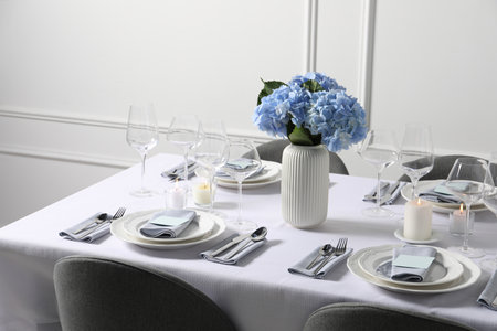 Beautiful table setting with floral decor indoorsの写真素材