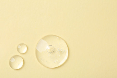 Samples of cosmetic serum on beige background, flat lay. Space for textの写真素材