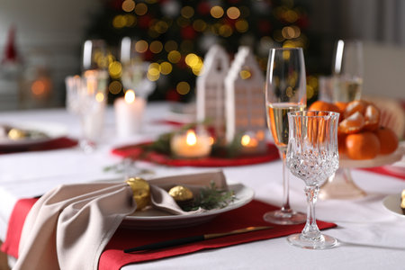 Christmas table setting with beautiful napkin, cutlery and dishware indoorsの写真素材