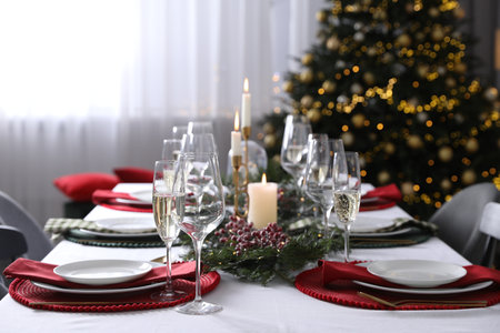 Christmas table setting with festive decor and dishware indoorsの写真素材
