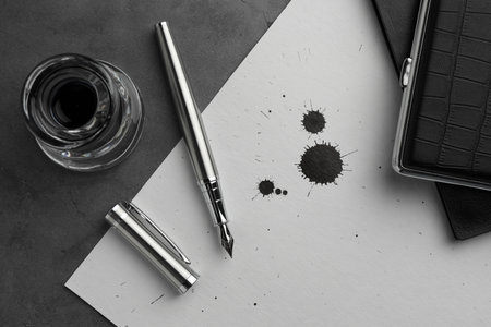 Flat lay composition with stylish fountain pen on gray textured tableの写真素材