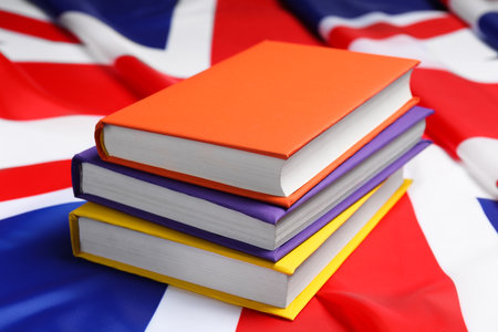 Learning foreign language. Different books on flag of United Kingdomの写真素材