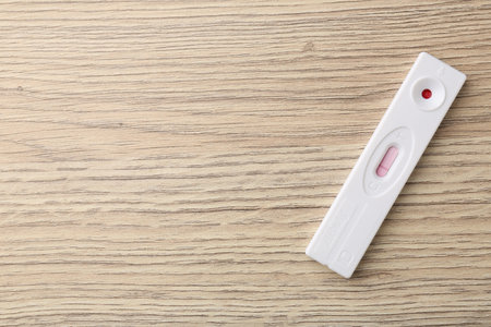 One disposable express test on wooden table, top view. Space for textの写真素材