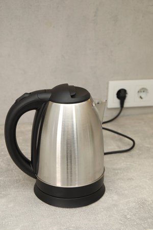 Modern electric kettle on counter in kitchen