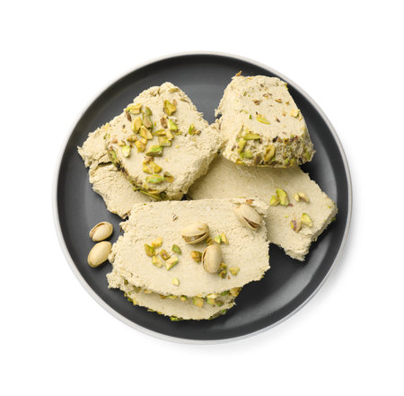 Pieces of tasty halva with pistachios on white background, top viewの写真素材