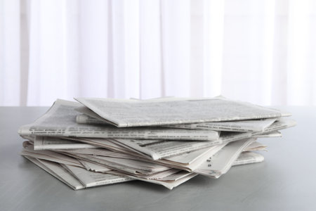 Pile of newspapers on gray table. Journalist's workの写真素材
