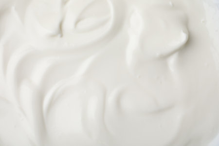 Delicious natural yogurt as background, top view