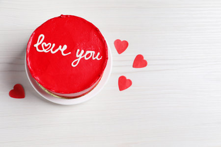 Bento cake with text Love You, paper hearts and space for text on white wooden table, top view. St....
