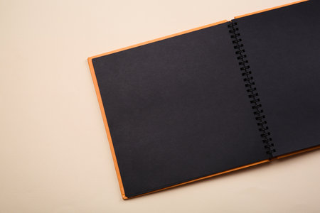 Open photo album on beige background, top view. Space for textの写真素材